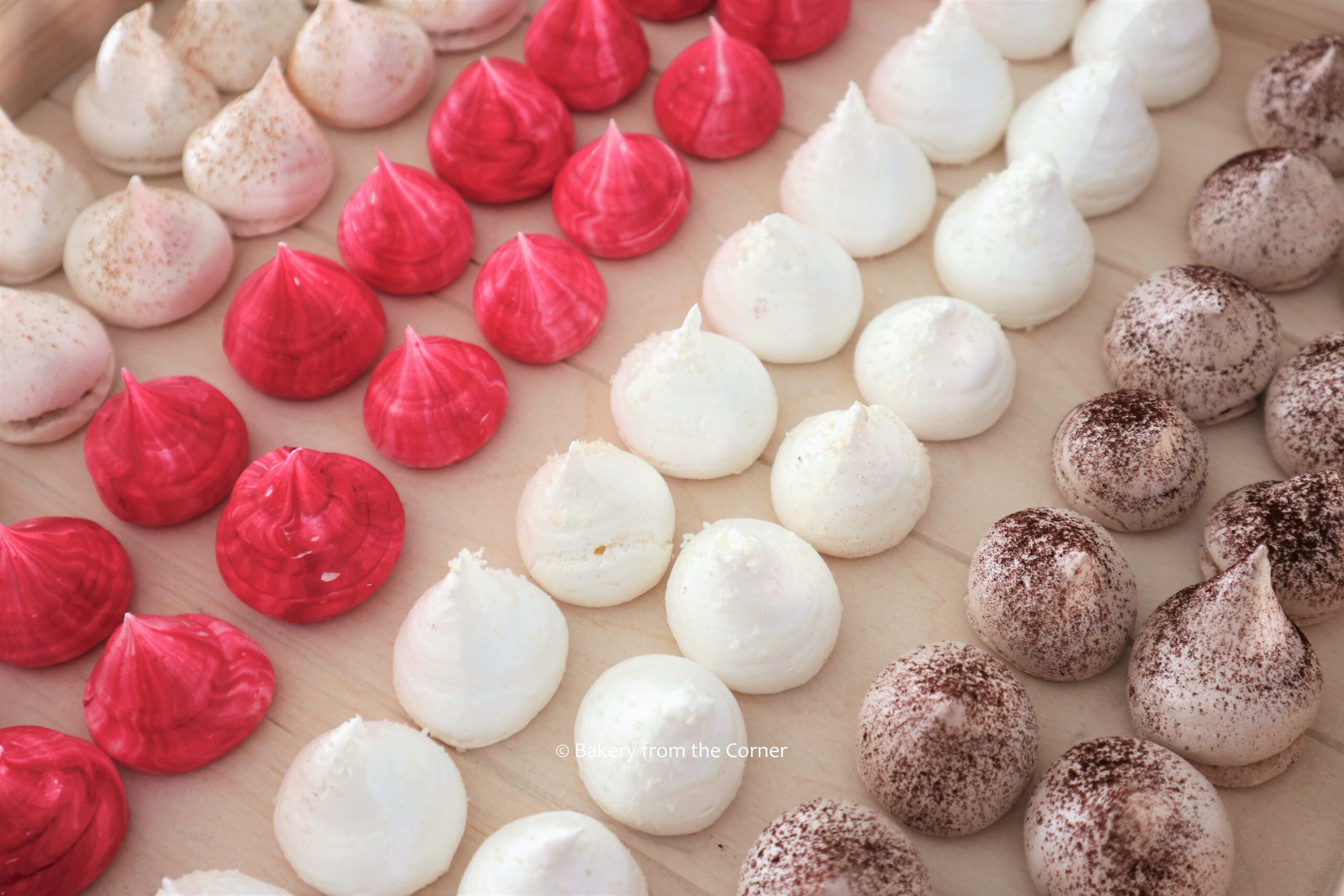 Meringue kisses Kleurrijke meringue schuimpjes met vanille, kaneel, kokos en cacao